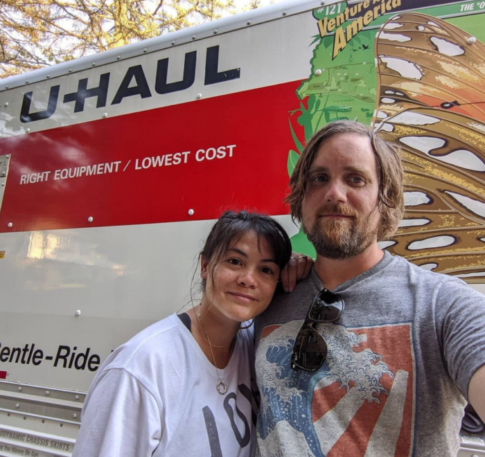 Melissa and Brad standing in front of a Uhaul truck