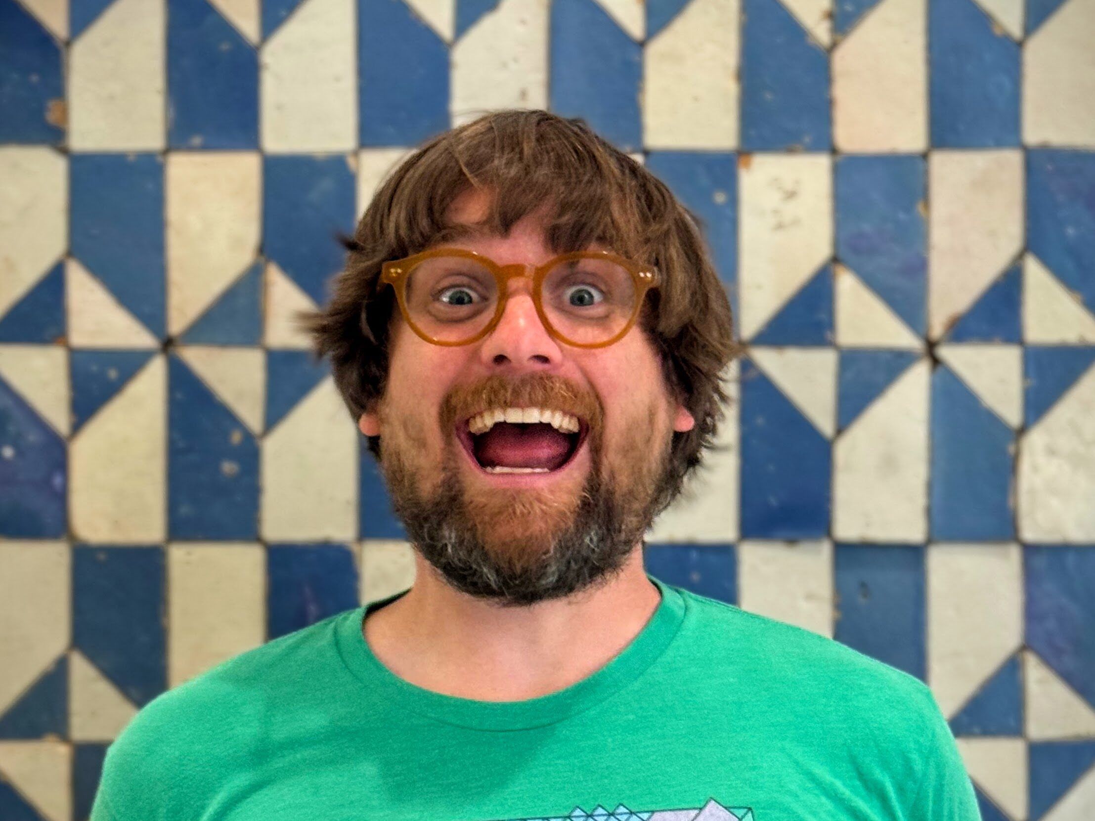 Brad Frost wearing glasses and a green tshirt with a big smile on his face.