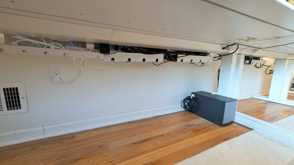 An under-desk view of organized cables