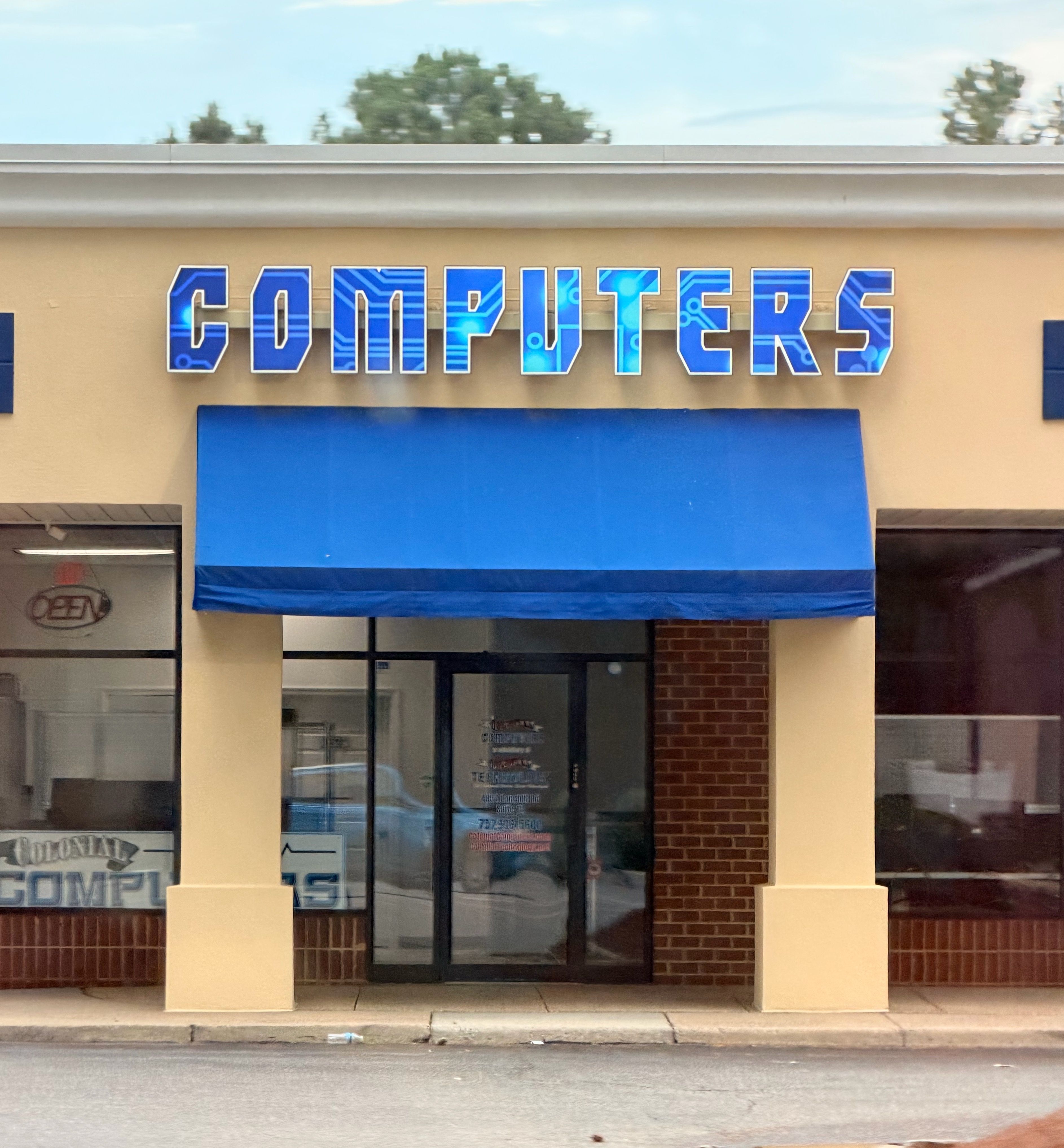 A store that has a sign that simply says “COMPUTERS” with microchip design