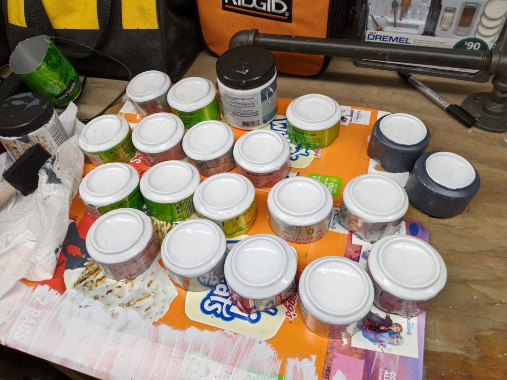 19 aluminum cans turned upside-down and with the bottoms painted white