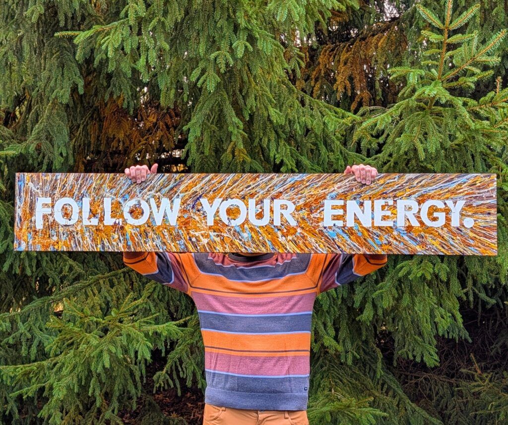 Brad holding his art piece "Follow your energy"