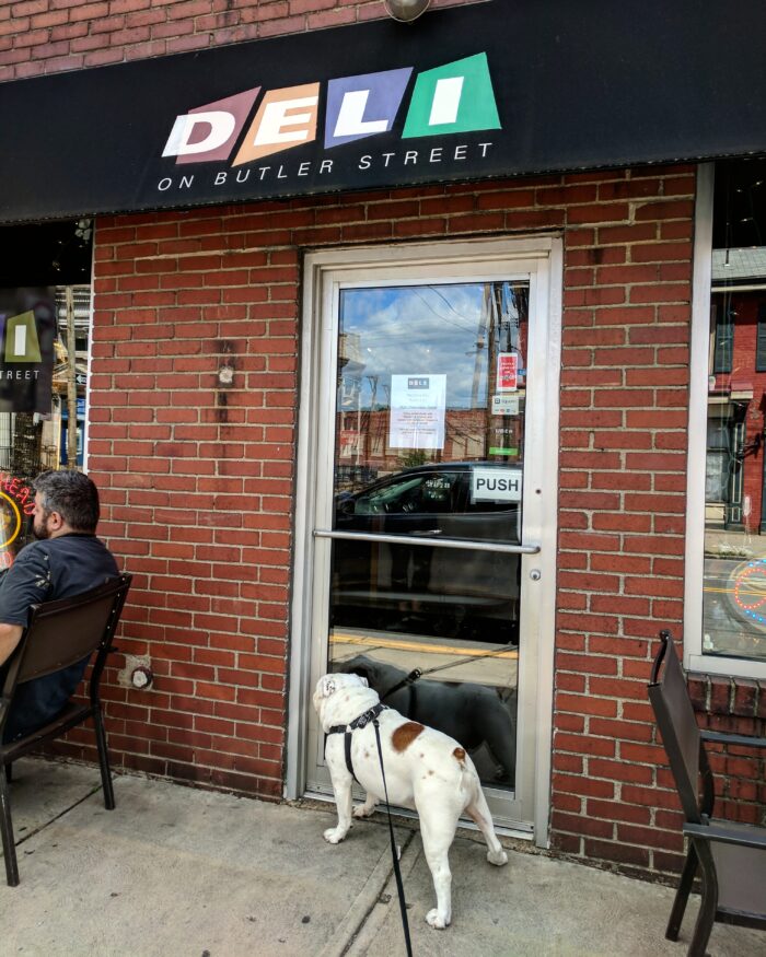 Ziggy standing in front of the Deli on Butler St