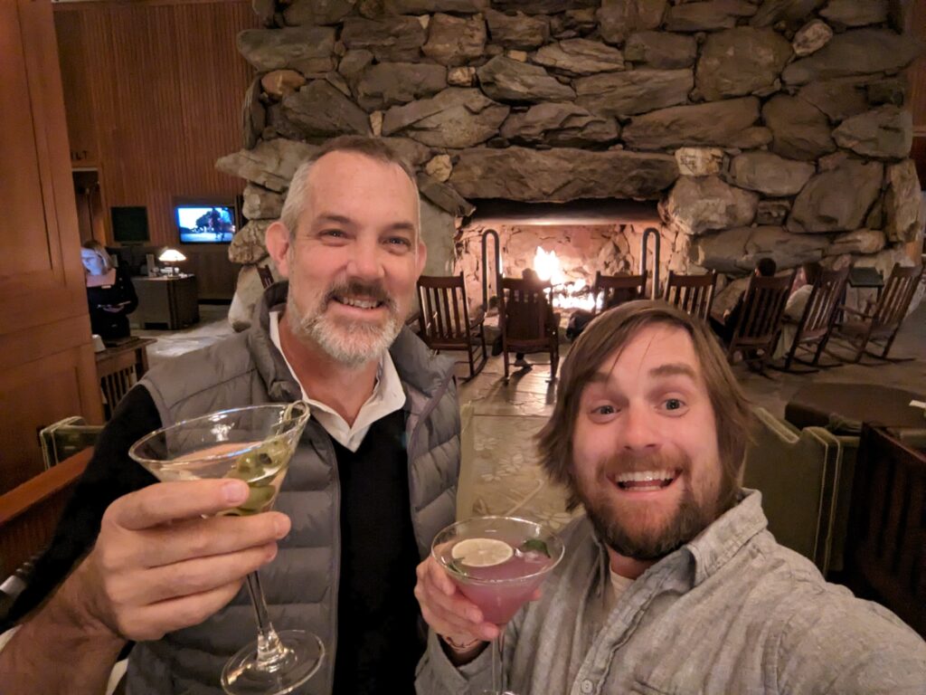 Josh Clark and Brad Frost sharing a fancy coctail in front of a giant fireplace in Asheville, NC