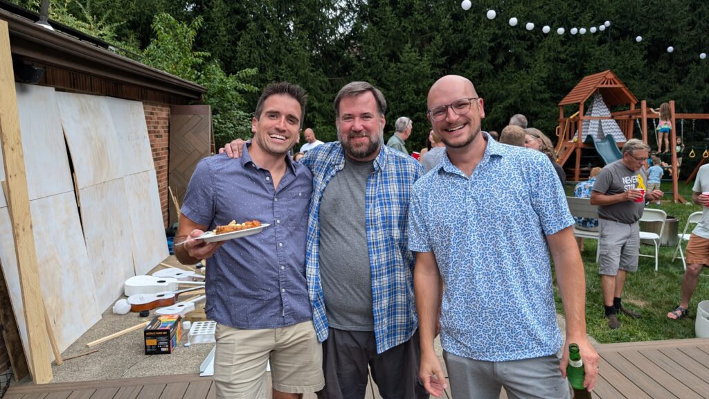 Ian Frost, Dave Olsen, And Brian Muenzenmeyer smiling at the Frostapalooza pre-party