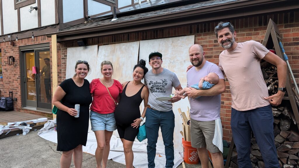 Krystle, Kate, Eva, Art, Eric holding baby Noel, and Nik