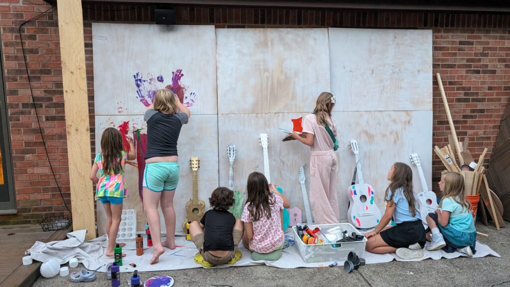 Kids painting a mural at the Frostapalooza pre-party