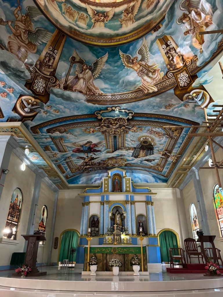 The interior of a church in Bohol in The Philippines featuring beautiful hand-painted ceilings