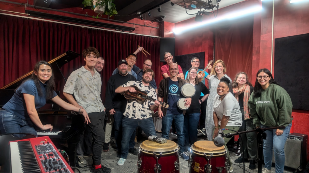 All of the Smashing Conf jam session attendees posing in a music space