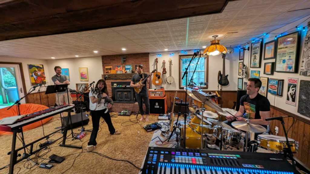 Aaron, Melissa, Bootsy, Will, and Ian preparing to play music in Brad's basement music studio